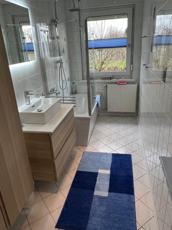 a bathroom with a sink and a tub and a toilet at Ferienhaus an der Mühle in Klütz