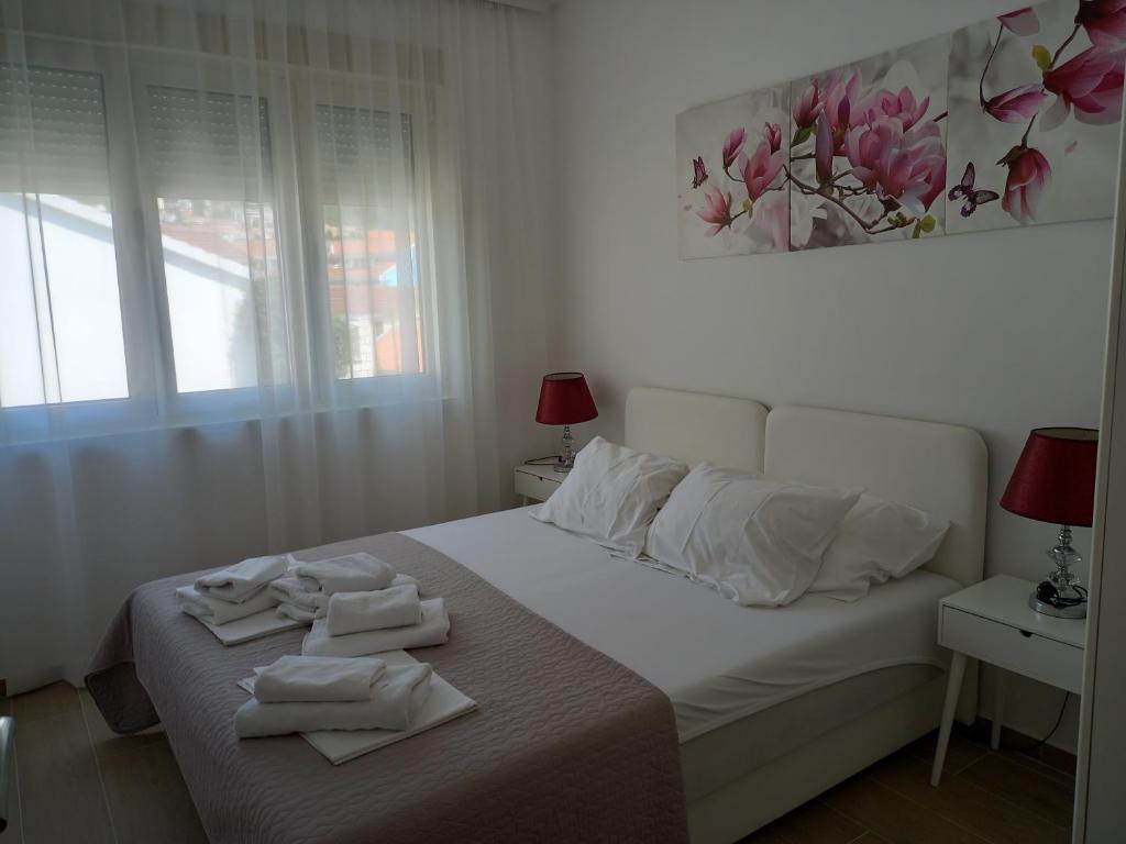 a bedroom with a bed with towels on it at Solaris Apartments in Budva