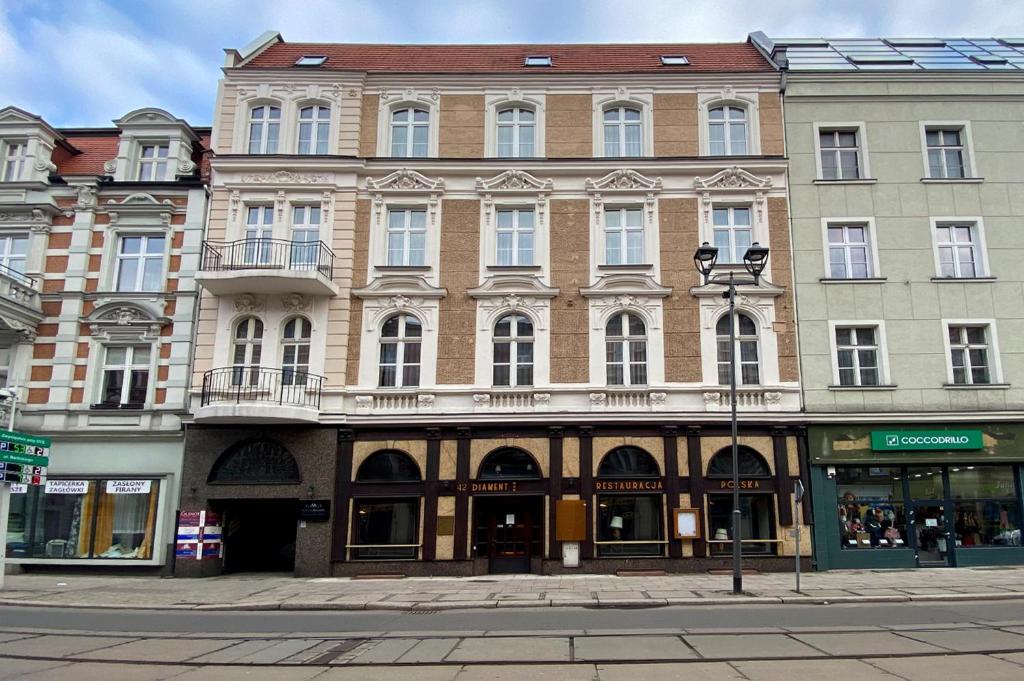 a large building on the corner of a street at Hotel Diament Economy Gliwice in Gliwice