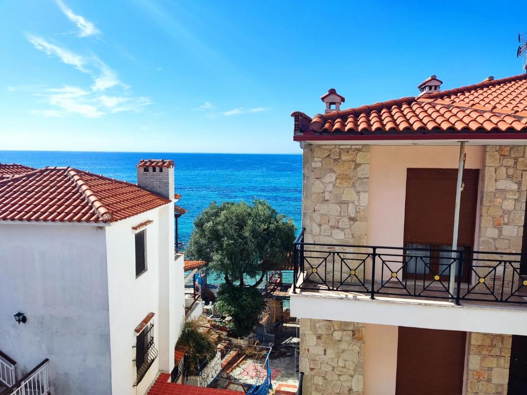 a view of the ocean from between two buildings at Chrusanthi's Apartment in Nea Skioni