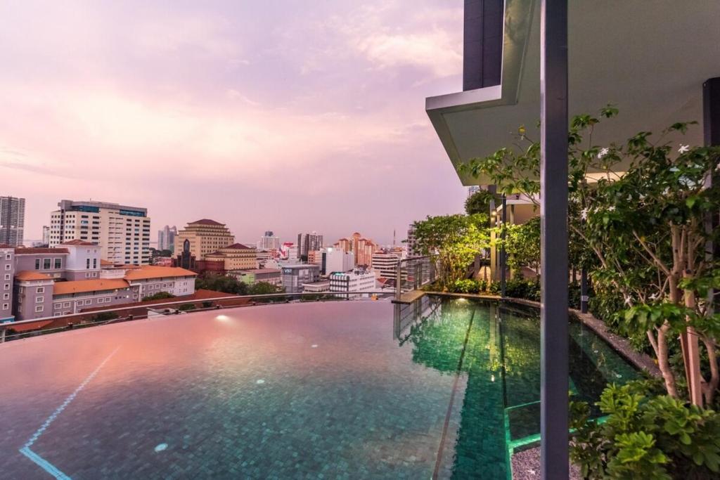 a swimming pool on the roof of a building with a city at Tropicana 218 Macalister Penang in George Town