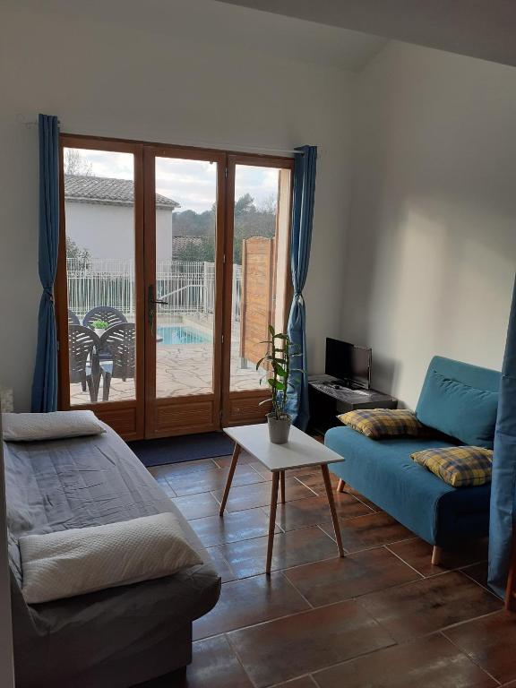 salon z kanapą i stołem w obiekcie maison mitoyenne avec piscine Un moment chez Diane w mieście Grasse