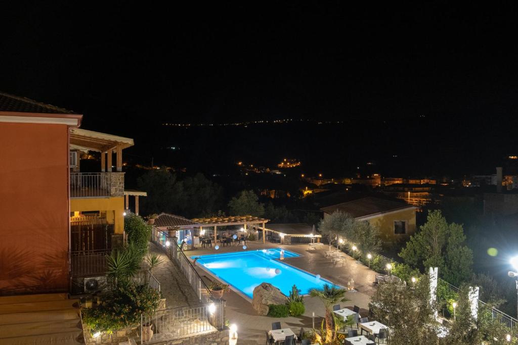 a view of a swimming pool at night at Cilento Holiday Village in Montecorice