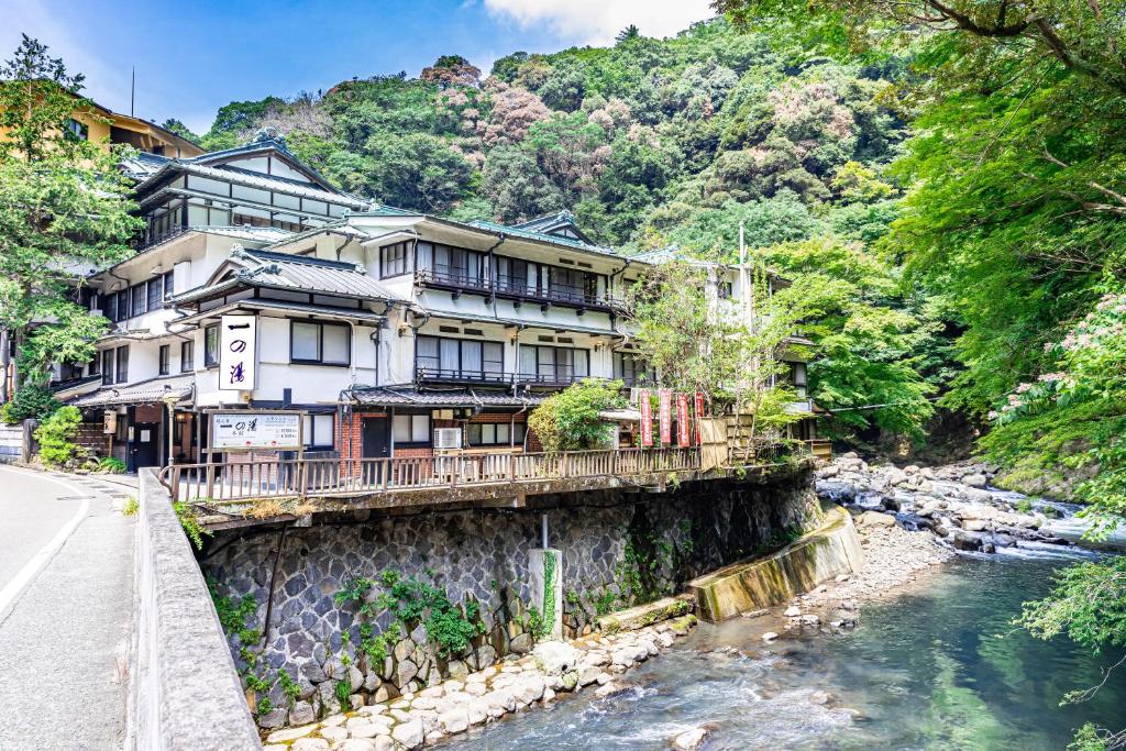 a building on a bridge over a river at Ichinoyu Honkan in Hakone