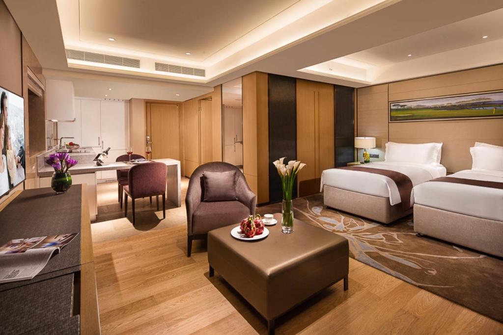 a hotel room with a bed and a desk at Somerset Grandview Shenzhen in Shenzhen