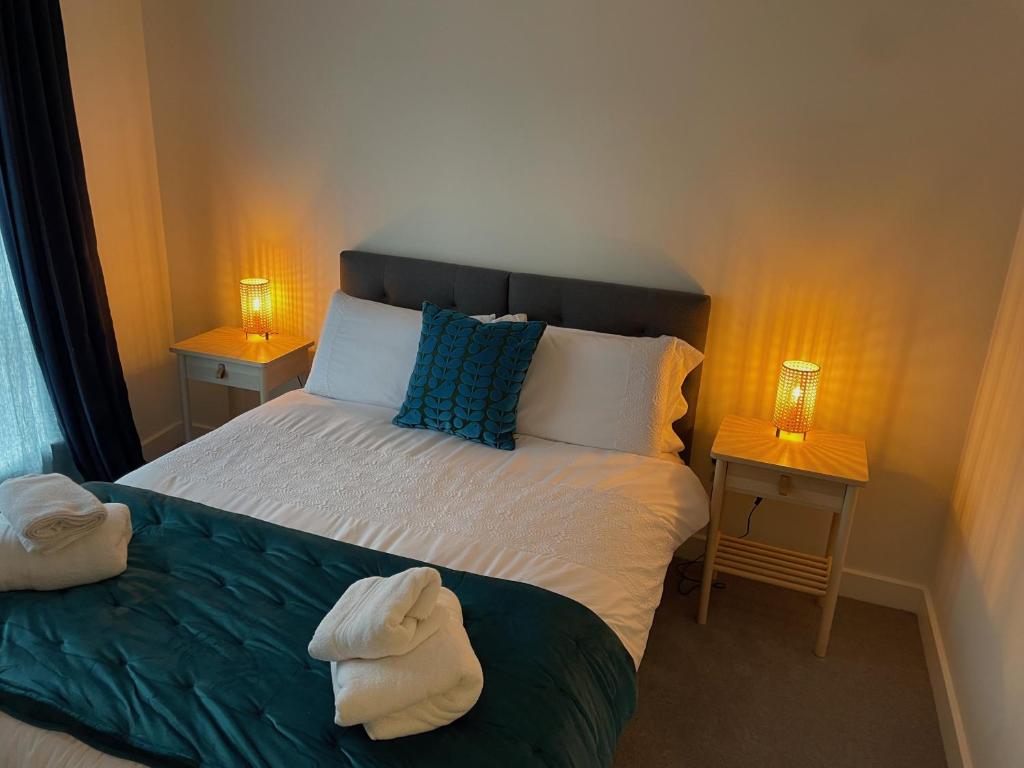 a bedroom with a bed with towels on it at Number 15 Luxurious Two Bedroom Apartment in Exmouth