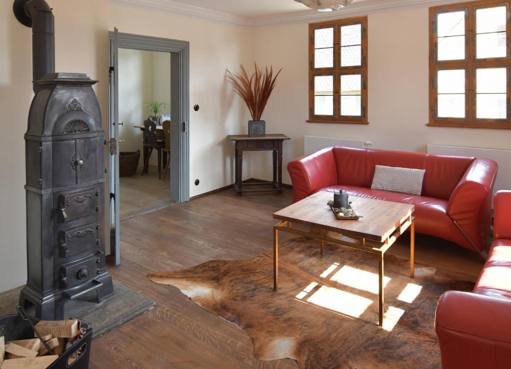 a living room with a red couch and a table at Ferienhaus Ickelhaus 1 in Bad Windsheim