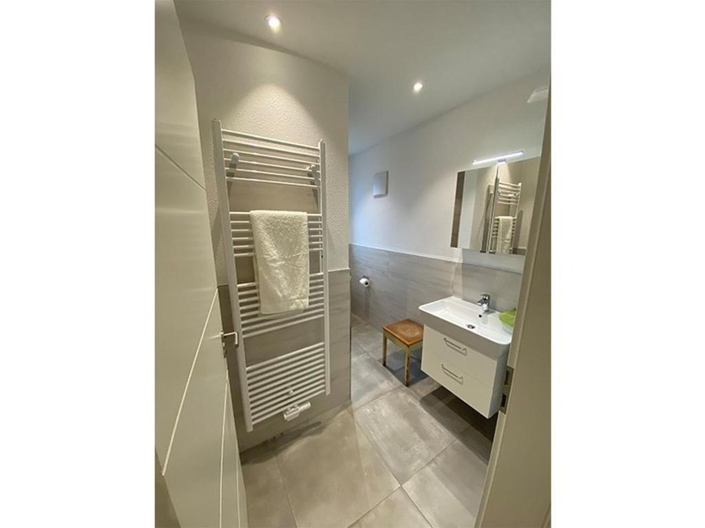 a bathroom with a sink and a mirror at Lemp's Genussgarten in Langenargen