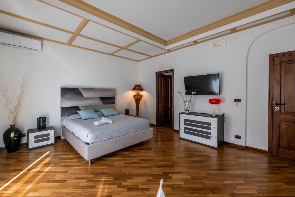 a bedroom with a bed and a flat screen tv at I Barcaioli in Giardini Naxos