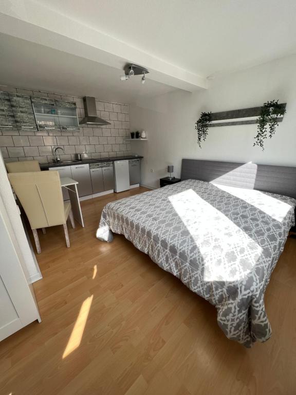 a large bedroom with a bed and a kitchen at Zimmer Am Wasser in Calden