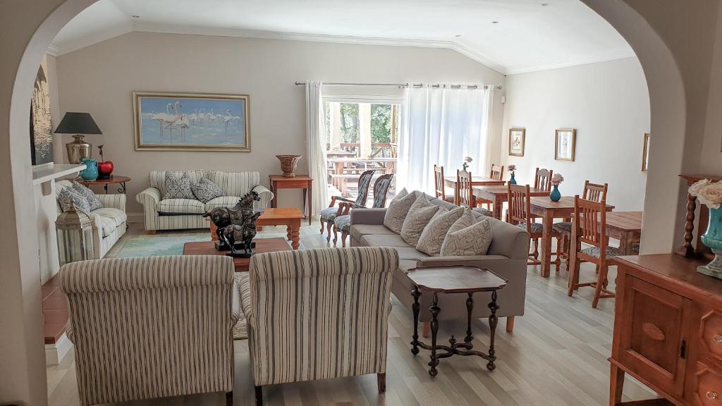 a living room with a couch and chairs and a table at Elephant Country Guest House in The Crags