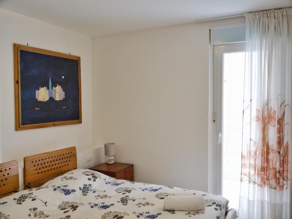 A bed or beds in a room at ROSE DE MAR - Grazioso appartamento con posto auto
