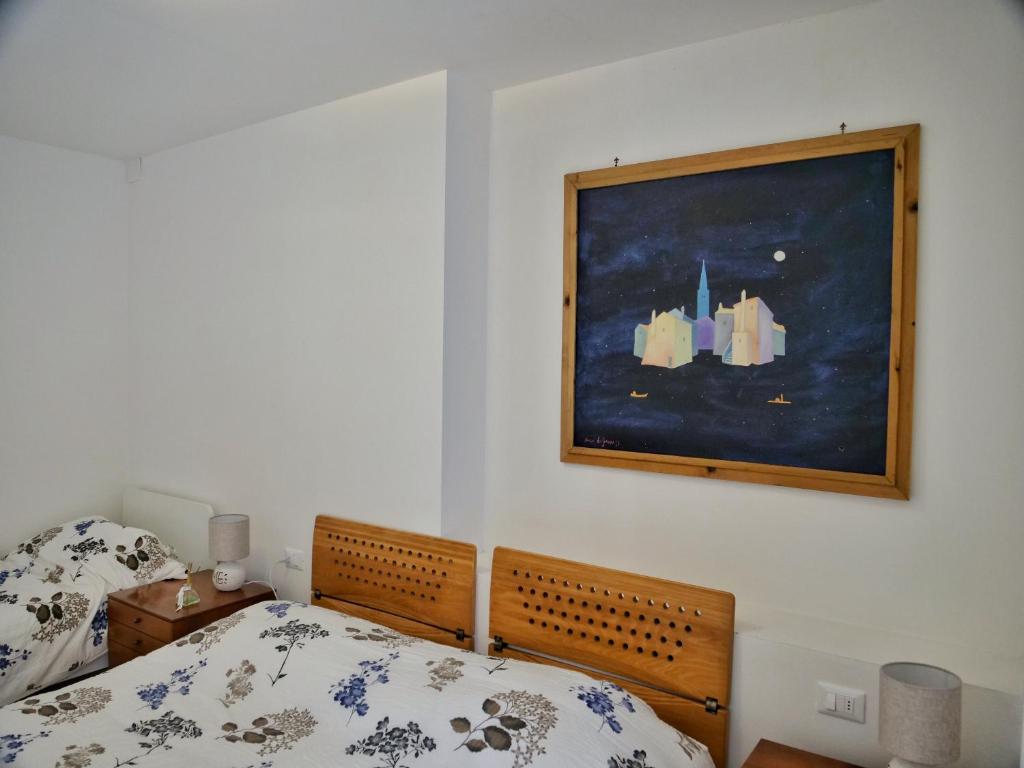 A bed or beds in a room at ROSE DE MAR - Grazioso appartamento con posto auto