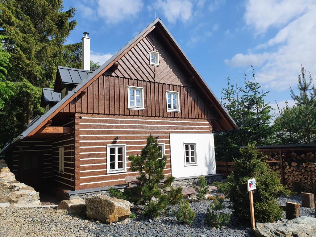 a log cabin with a gambrel roof at BP Chata Ostružná in Ostružná