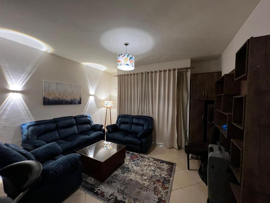 a living room with a blue couch and a table at New Cairo Modern Apartment in Cairo
