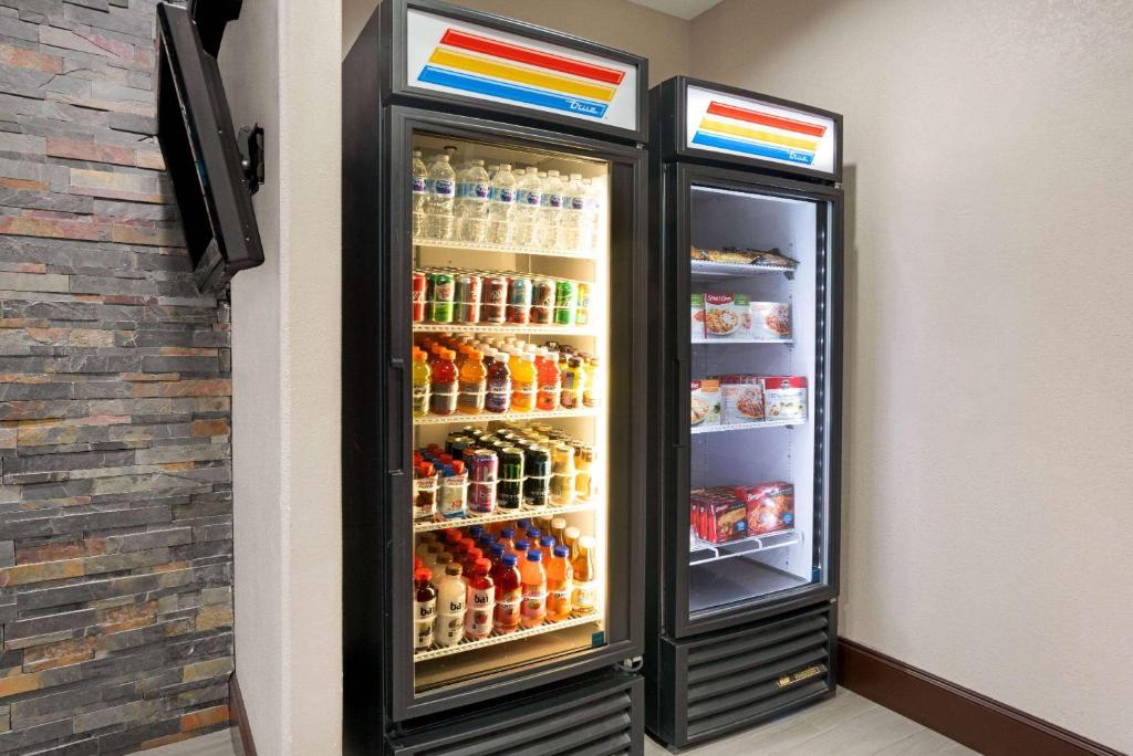 a refrigerator filled with lots of drinks at La Quinta by Wyndham Houston IAH Bush Intl Airport E in Humble