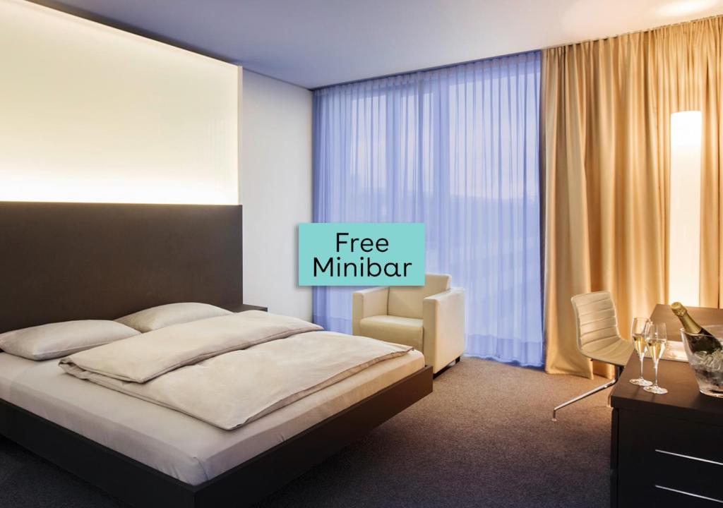 a bedroom with a bed with a free member sign on it at INNSiDE by Meliá Düsseldorf Derendorf in Düsseldorf
