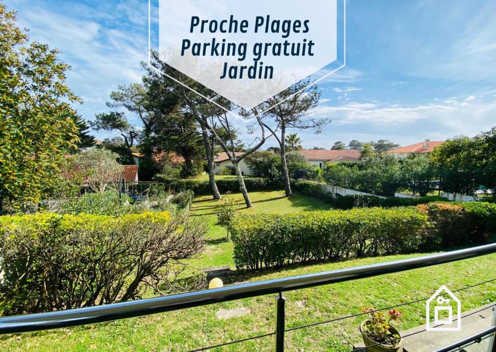 a view of a garden from the balcony of a house at Maison des Dunes, T2, proche plage et forêt in Anglet