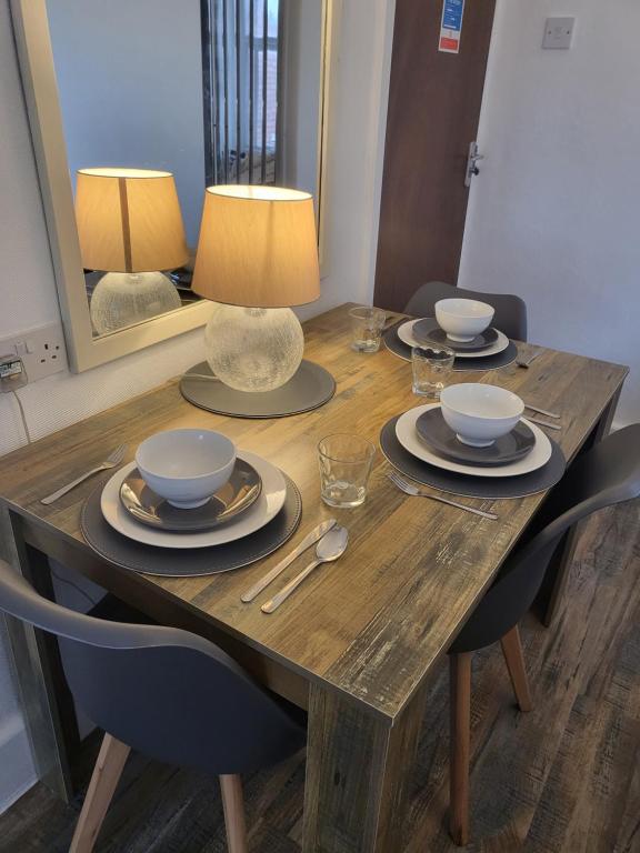 a wooden table with plates and bowls on it at 140 Bond in Blackpool