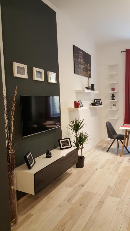 a living room with a flat screen tv on a wall at Home, far away from Home 2 in Budapest