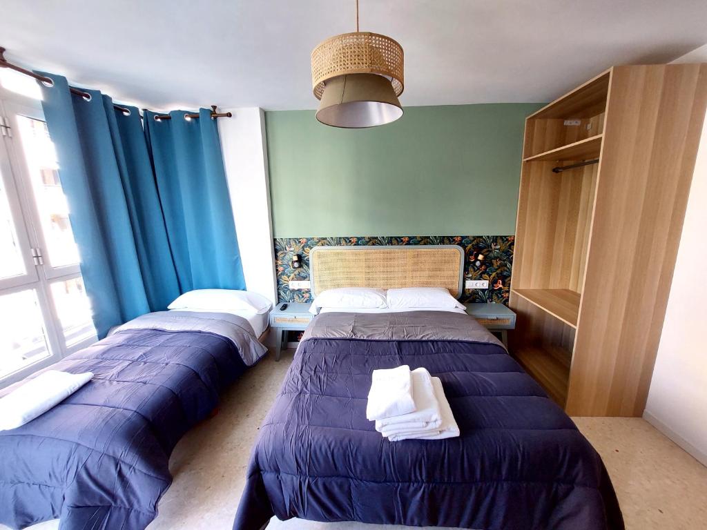 Postel nebo postele na pokoji v ubytování Habitaciones Barra89