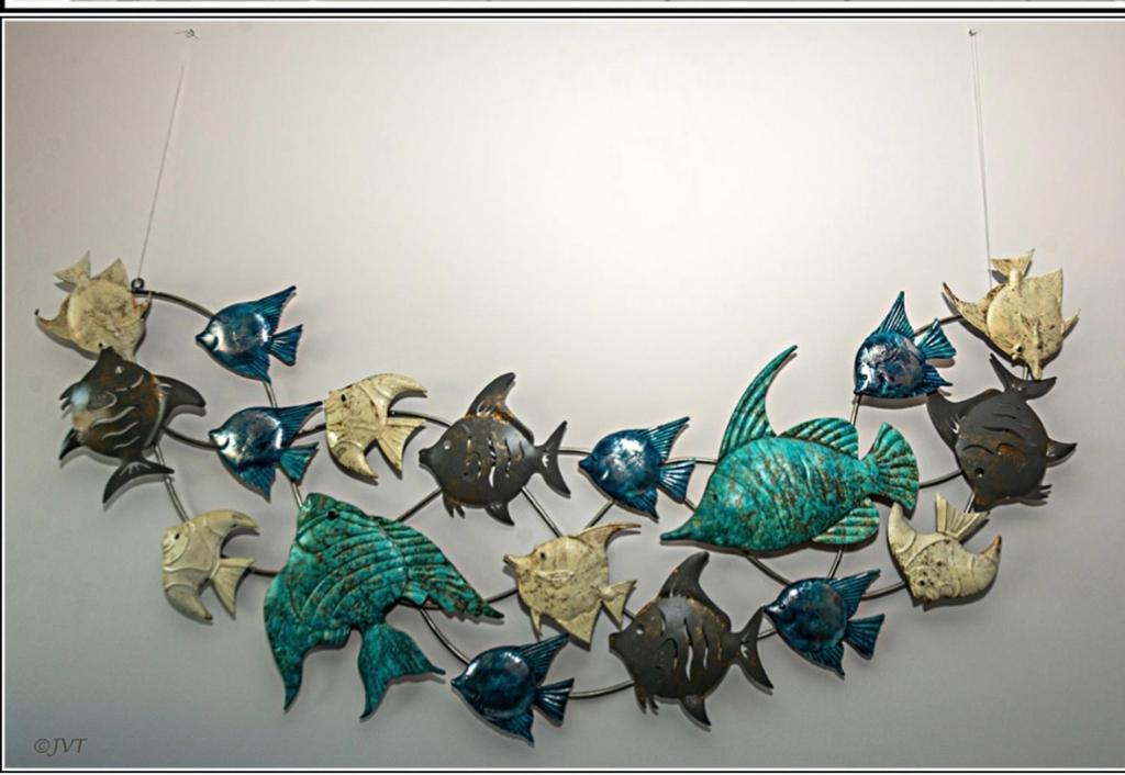 a group of fish hanging on a wall at Zeedijk Appartement in Knokke-Heist
