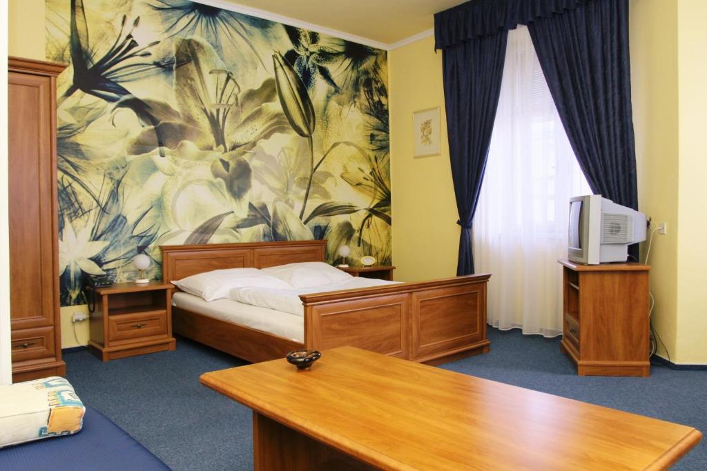 Postel nebo postele na pokoji v ubytování Hotel Růžek