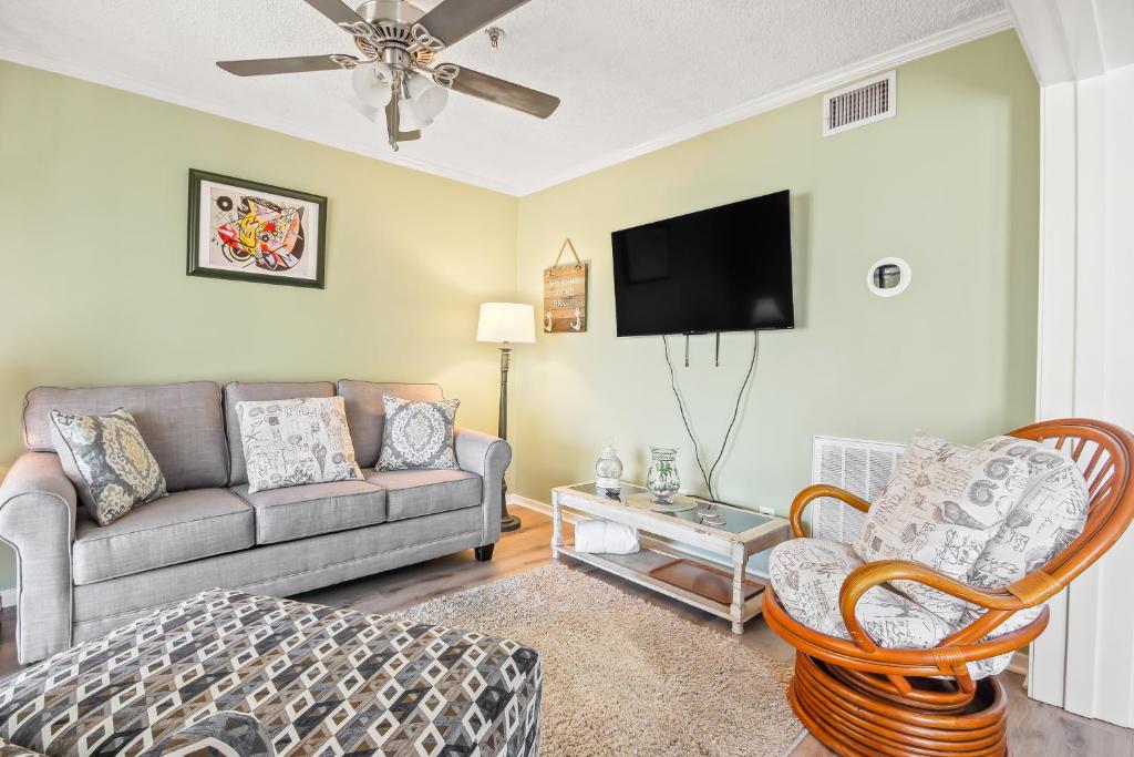 a living room with a couch and a tv at Hillside 304 in Myrtle Beach