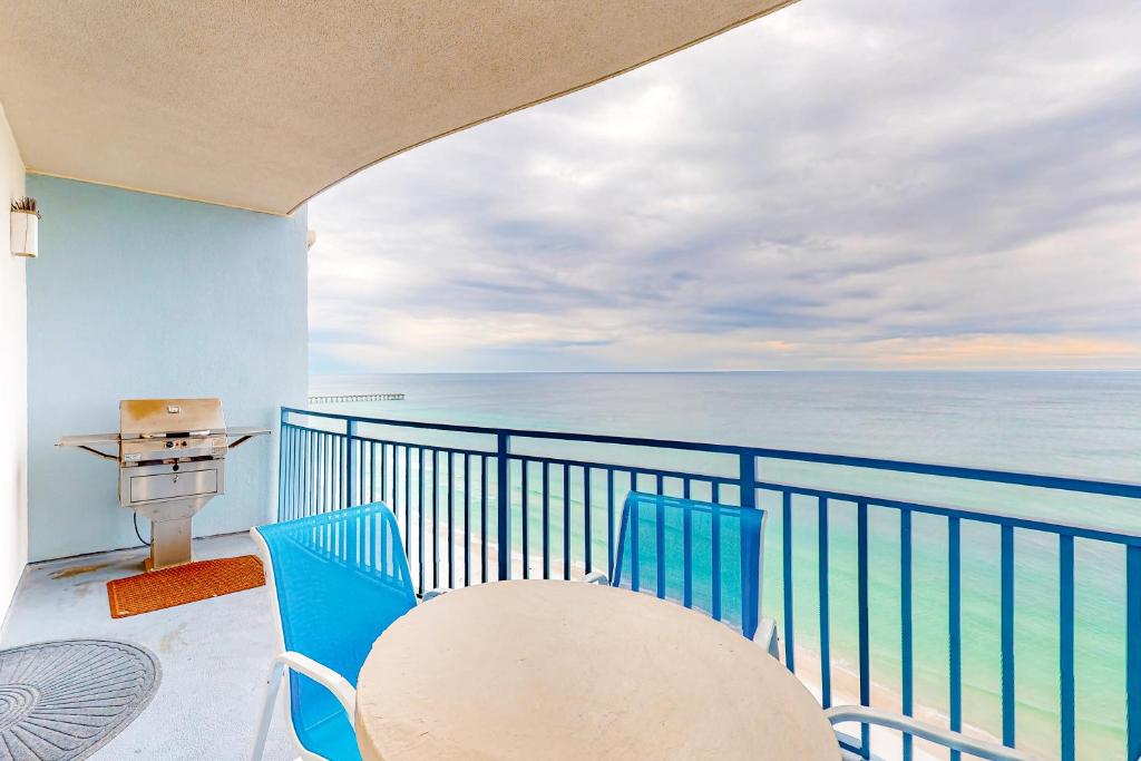 a balcony with a table and chairs and the ocean at Sterling Breeze 1705 in Panama City Beach
