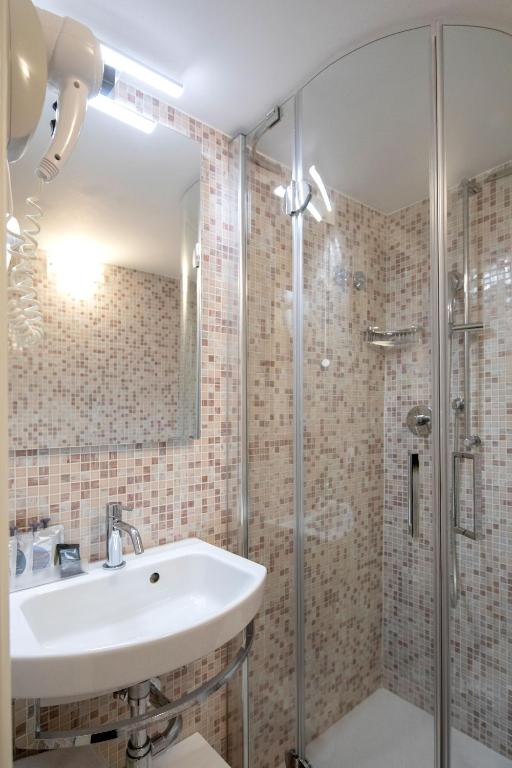 a bathroom with a sink and a shower at Alle Guglie Boutique Hotel in Venice