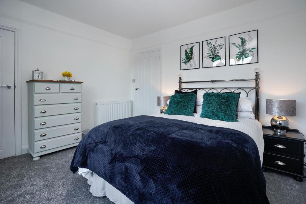 a bedroom with a large bed and a dresser at Cowdray Avenue in Colchester