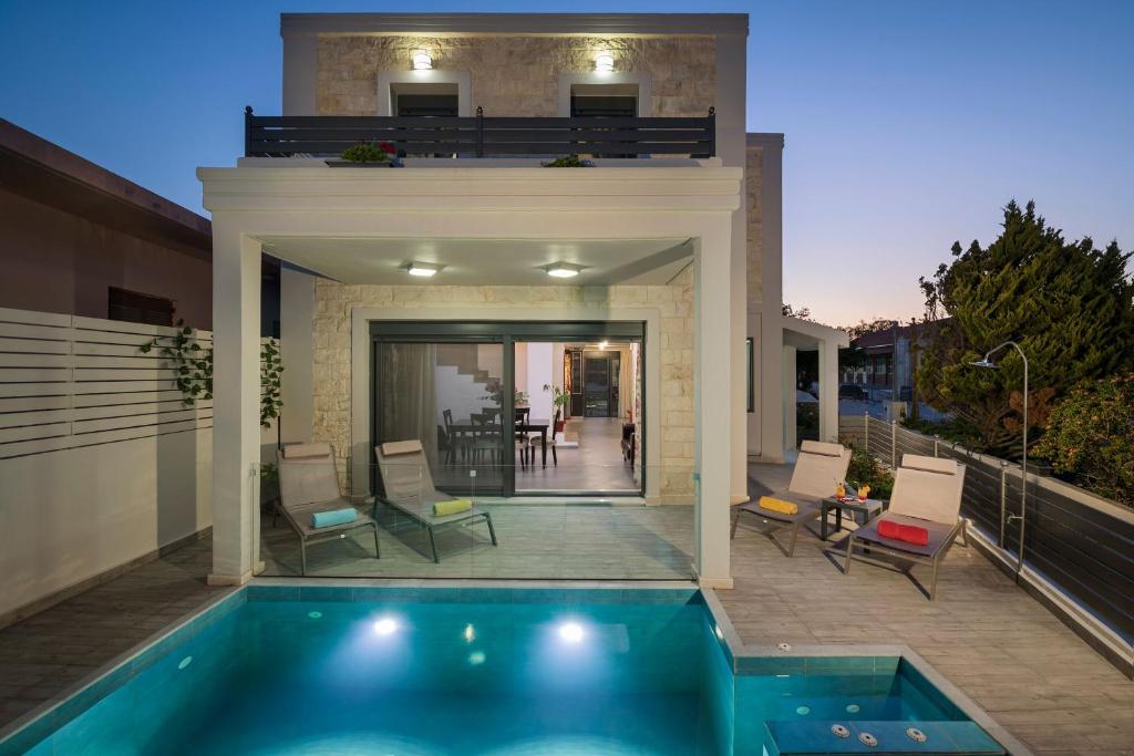 a house with a swimming pool in front of a house at Villa Antoni in Galatás