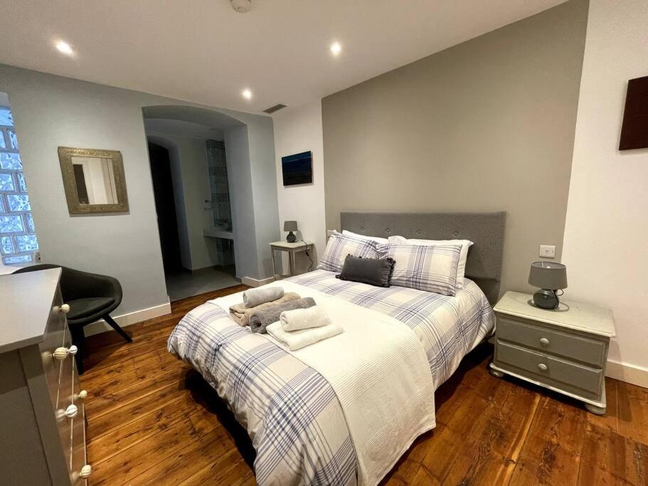 a bedroom with a bed with towels on it at Stylish 2BR contemporary design perfect vacation in Gibraltar