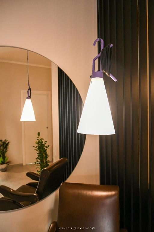 a room with chairs and a mirror and lights at Casa Ferretti apartment in Brindisi