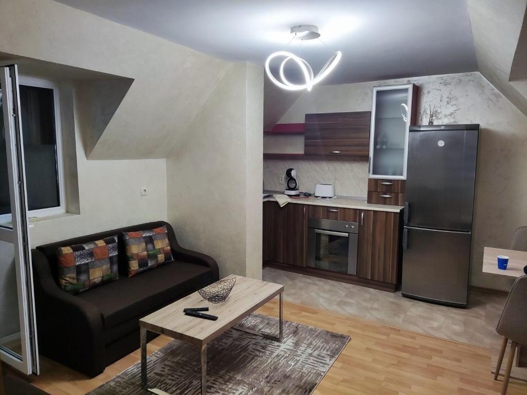 a living room with a couch and a kitchen at Apart Centar in Plovdiv