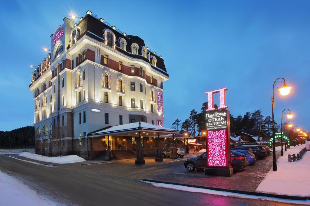 a large white building with a sign in front of it at Palais Royal in Yekaterinburg