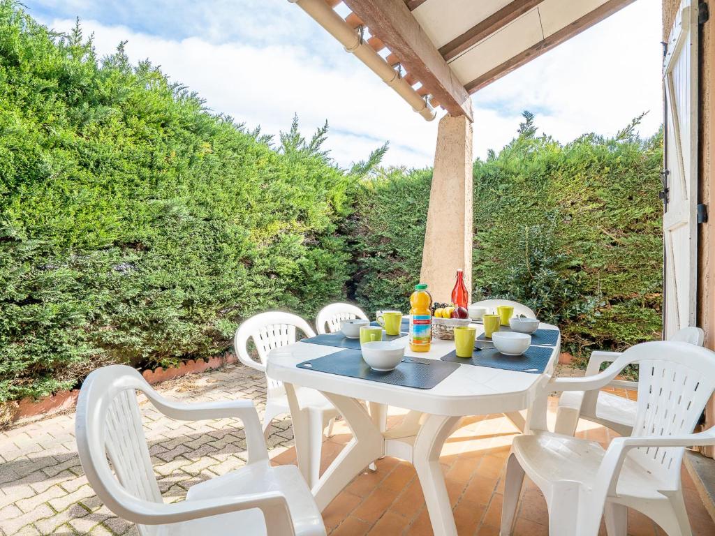 a white table and chairs on a patio at Holiday Home Les Aloès by Interhome in Sainte-Marie-la-Mer