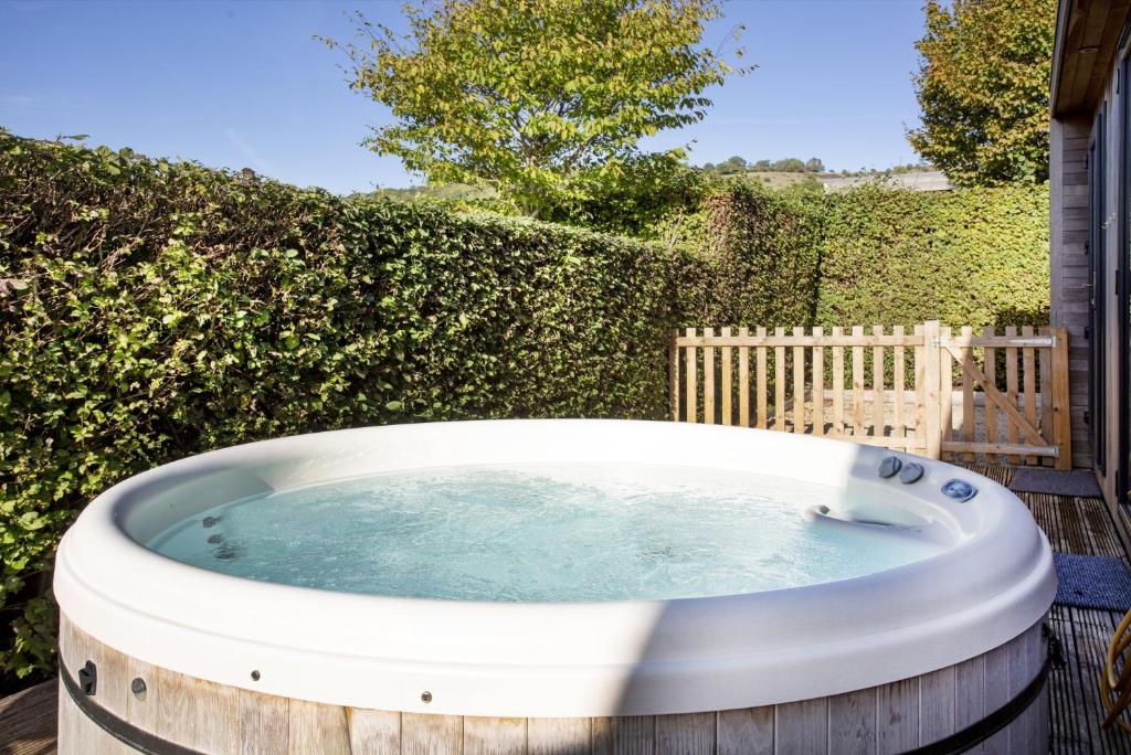 a hot tub in a barrel in a yard at Whileaway Lodge, Strawberryfield Park in Cheddar