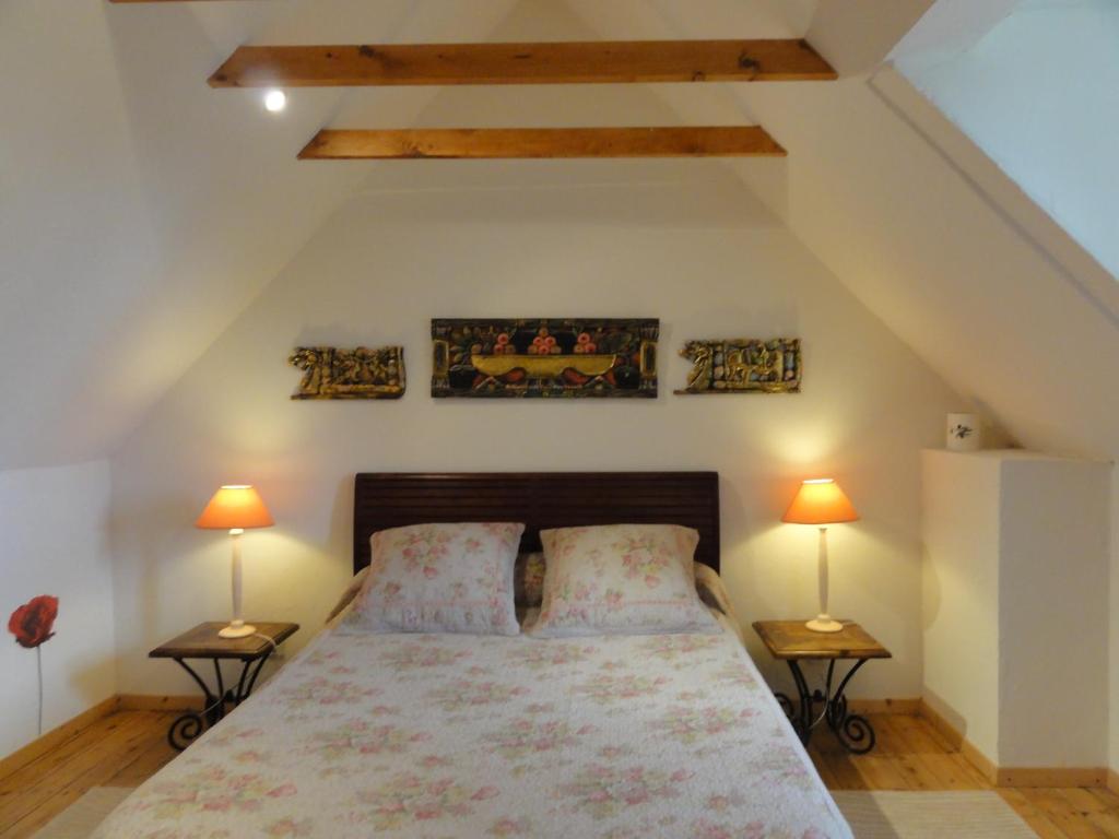 a bedroom with a large bed with two lamps at Chambres d&#39;hôtes Air Marin in Lannion