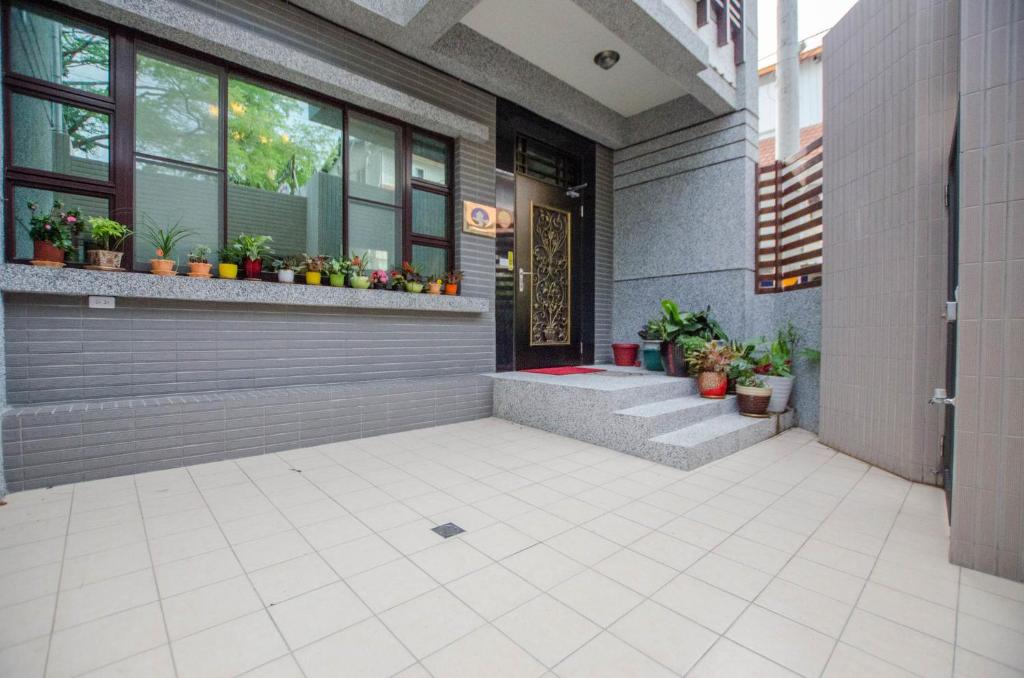 a front door of a building with potted plants at Heyi B&amp;B in Taitung City