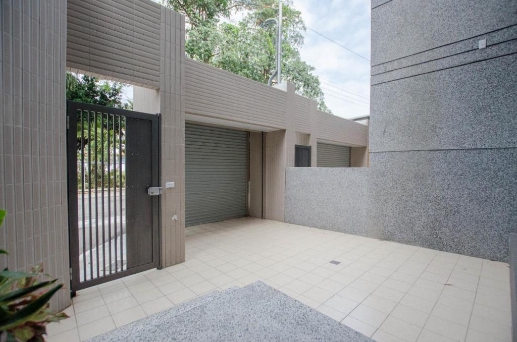 a building with a gate and a garage at Heyi B&amp;B in Taitung City