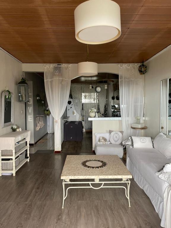 a living room with a couch and a table at Le balcon de l'océan in Saint-Gilles les Bains