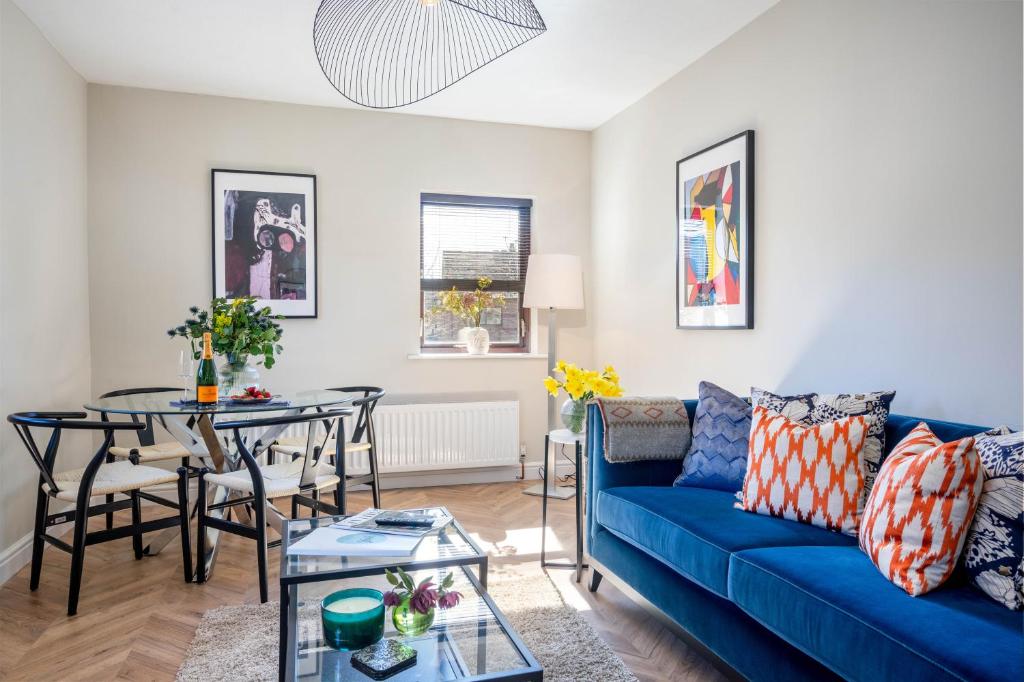 a living room with a blue couch and a table at Redfearn Apartment in York