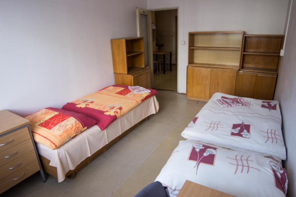 A bed or beds in a room at Apartments Kolej Vltava