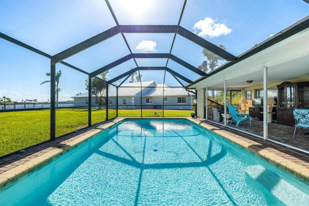 a swimming pool in a house with a glass roof at Heated Saltwater Pool, Sleeps 6 - Villa Shangri-La in Cape Coral
