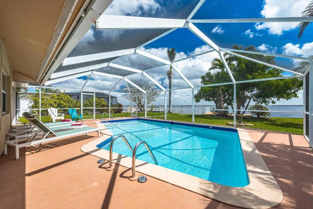 an image of a swimming pool in a house at Heated Pool, Ping Pong Table, Sleeps 10 - Villa Sunset Riverhouse in Cape Coral