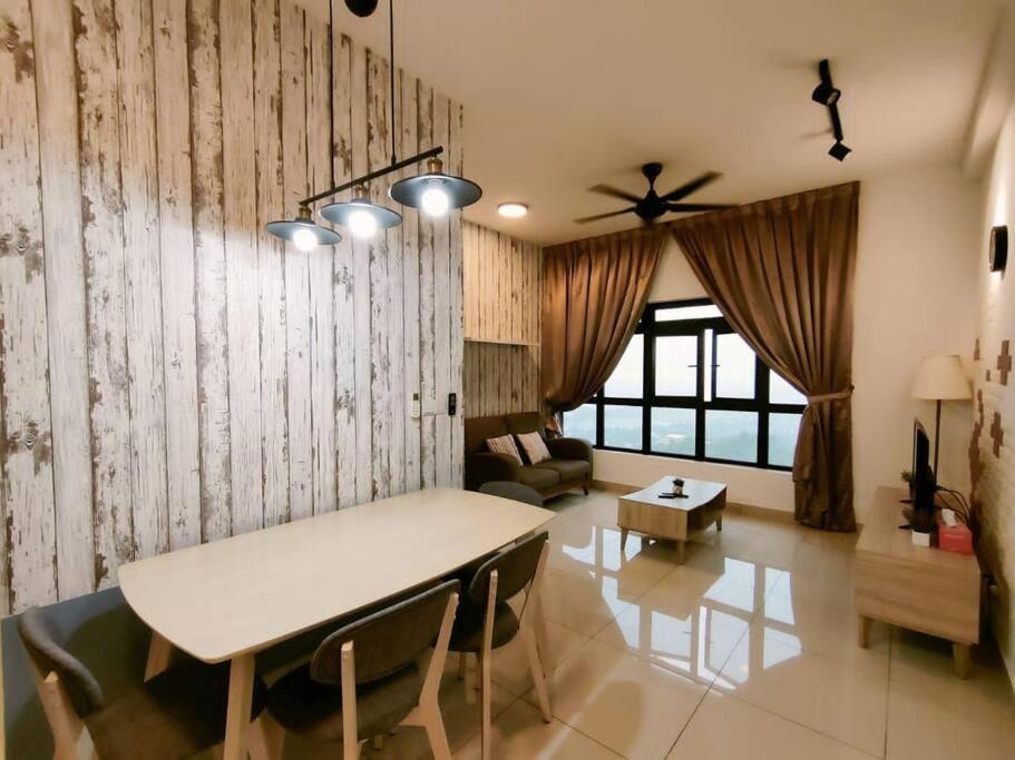 a living room with a table and a couch at Meridin Medini, Iskandar Puteri, Johor in Nusajaya