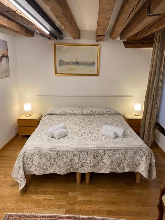 a bedroom with a bed with two towels on it at San Marco Loft in Venice