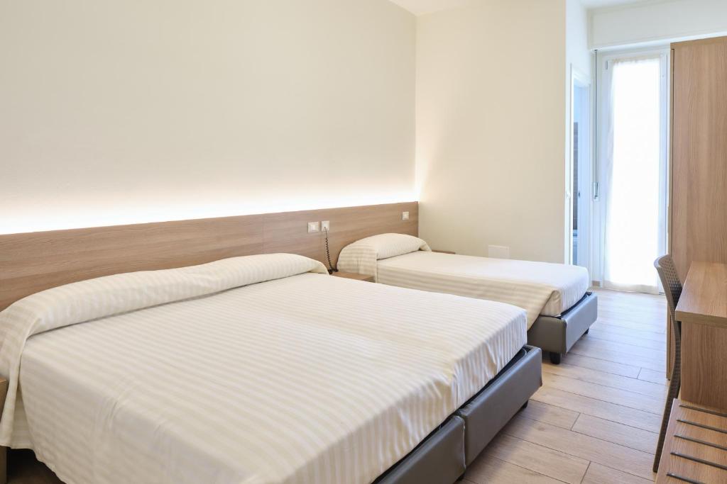 Łóżko lub łóżka w pokoju w obiekcie HOTELRISTORANTE IL PUNTO