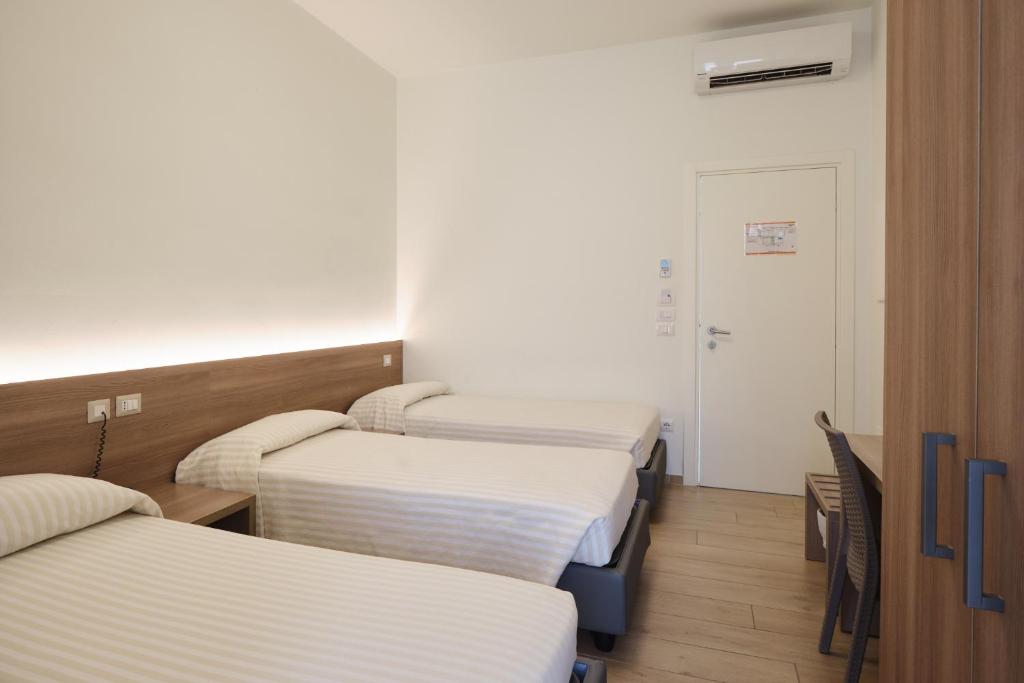 Łóżko lub łóżka w pokoju w obiekcie HOTELRISTORANTE IL PUNTO